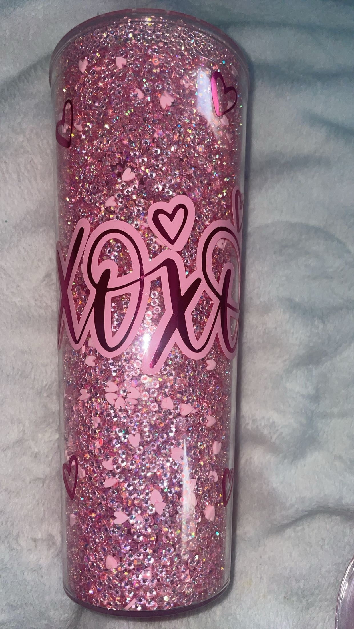 Hugs and kisses xoxo rhinestoned filled tumbler with vinyl decal.